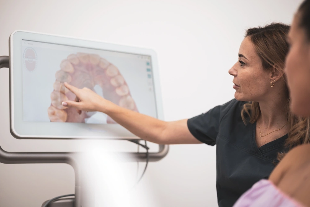 a dentist pointing to teeth