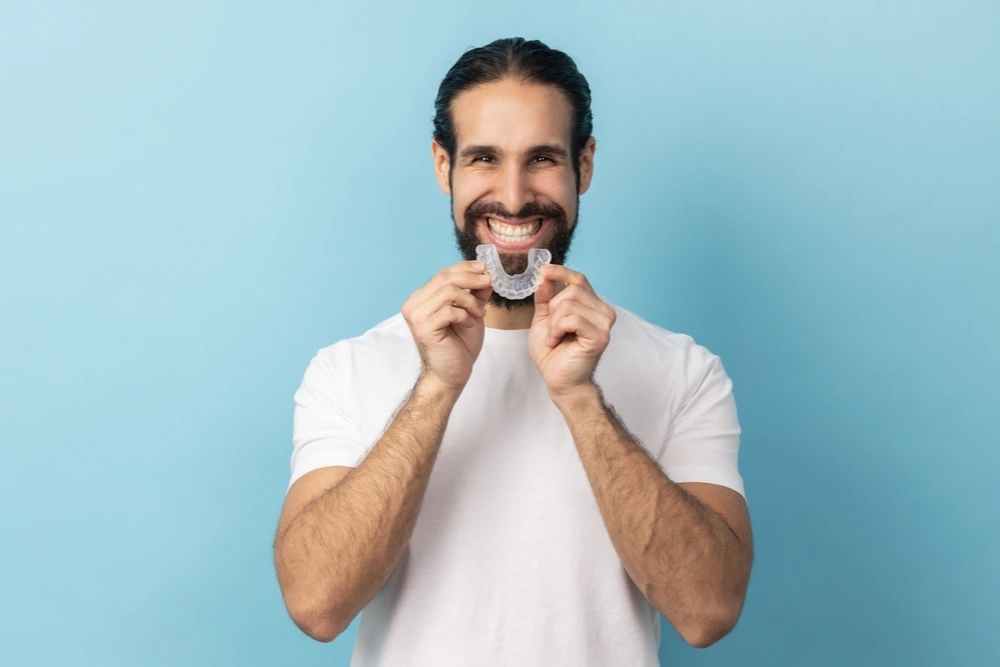 What are the advantages of clear ceramic braces for adults?