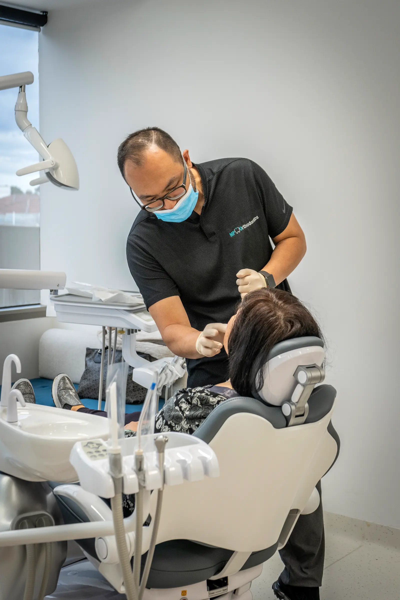 Patient being seen by Dr Martin Poon, performing a regular check-up appointment for Invisalign treatment