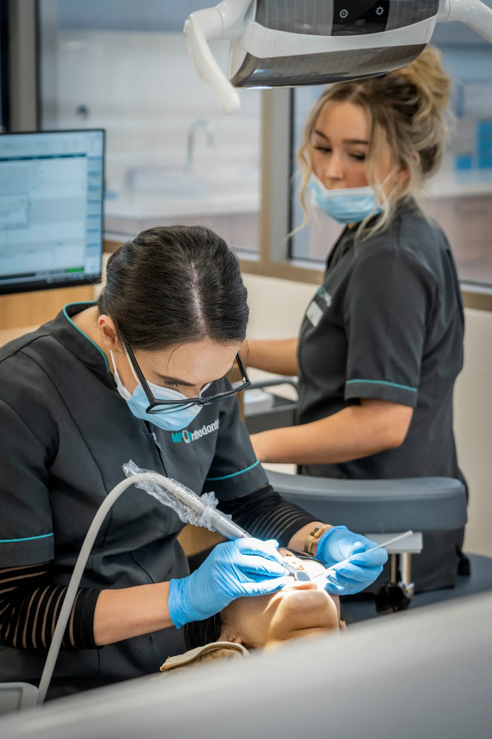 Patient receiving a regular clean and check-up during lingual braces treatment in Melbourne at MP Orthodontics