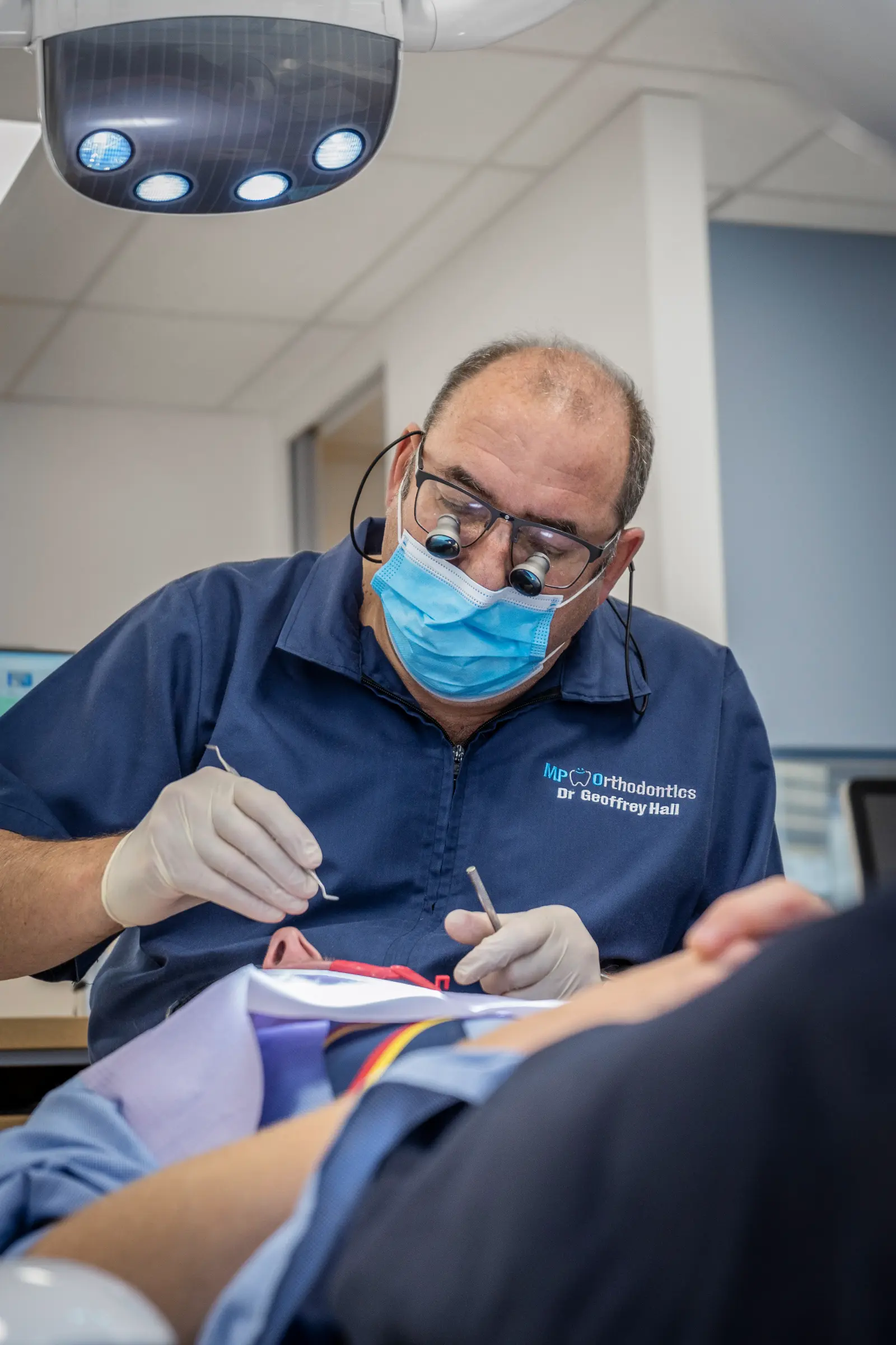 Dr Geoff Hall, orthodontics at MP Orthodontics using metal braces to align a patient's teeth