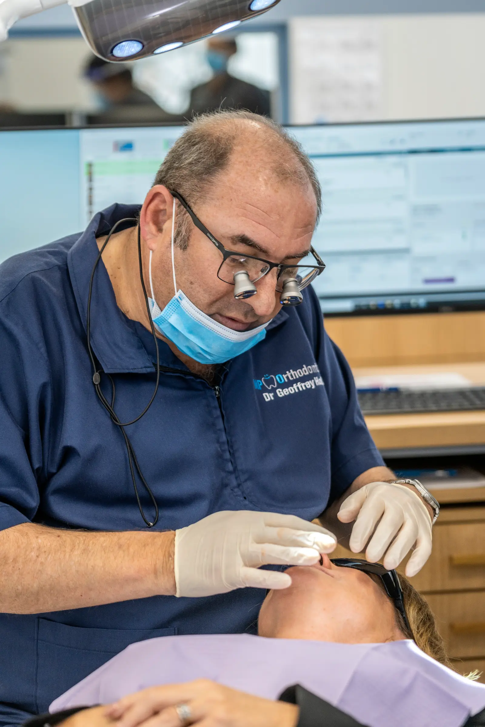 Dr Geoff Hall providing kids orthodontic treatment to child in Melbourne clinic MP Orthodontics