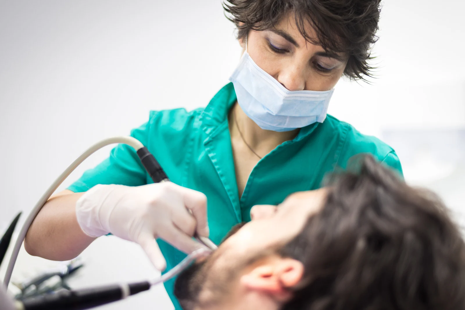 Orthodontist performing dental treatment to straighten teeth and improve bite alignment - MP Orthodontics