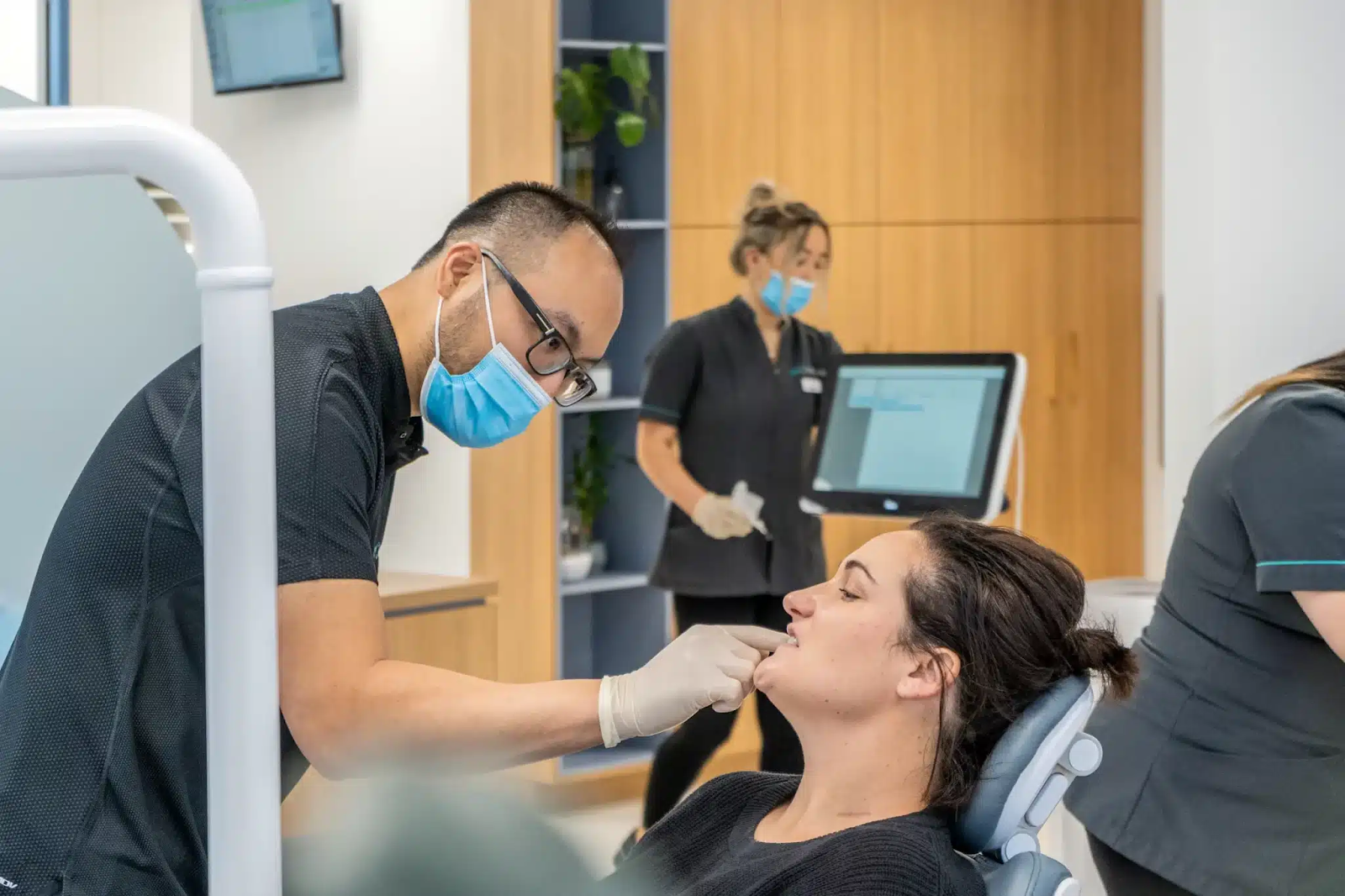 Dr. Martin Poon checking patient’s braces before recommending best mouthguard for protection - MP Orthodontics