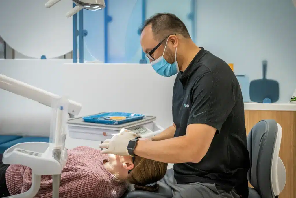 Dr. Martin Poon examining patient’s teeth for bite correction and alignment care - MP Orthodontics
